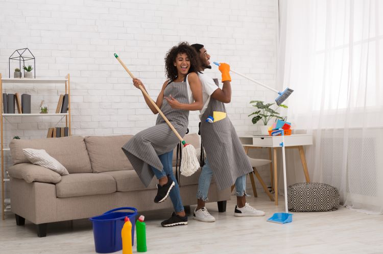 two people dancing while cleaning