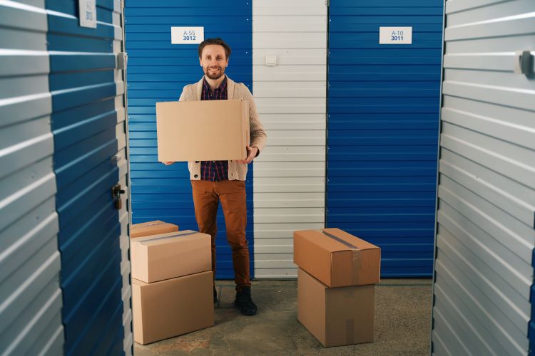 man holding boxes at a storage unit