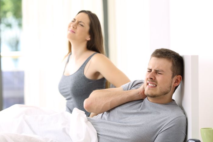 couple waking up in pain